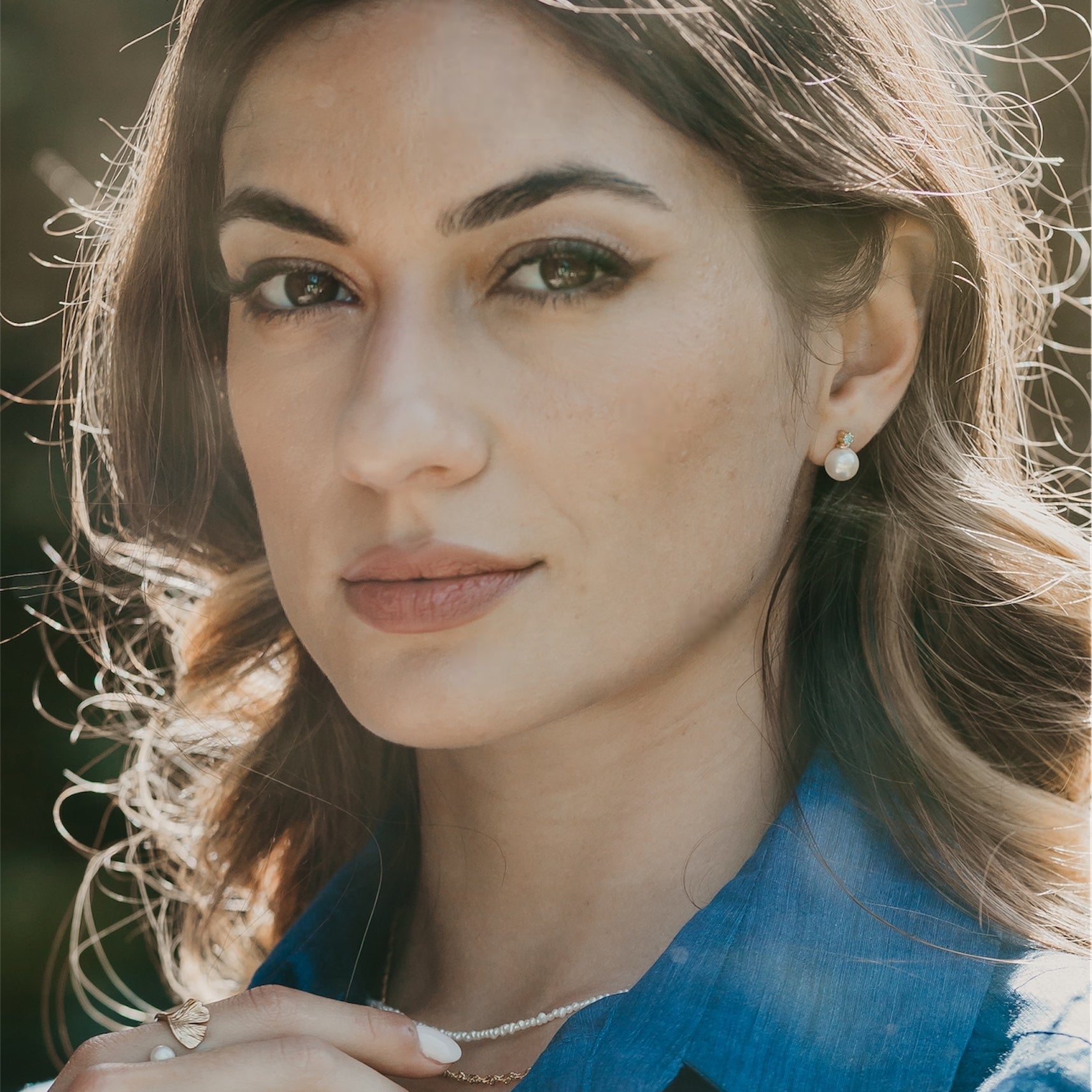 Pearl Obsession studs with blue topaz styled showing gemstone and pearl detail