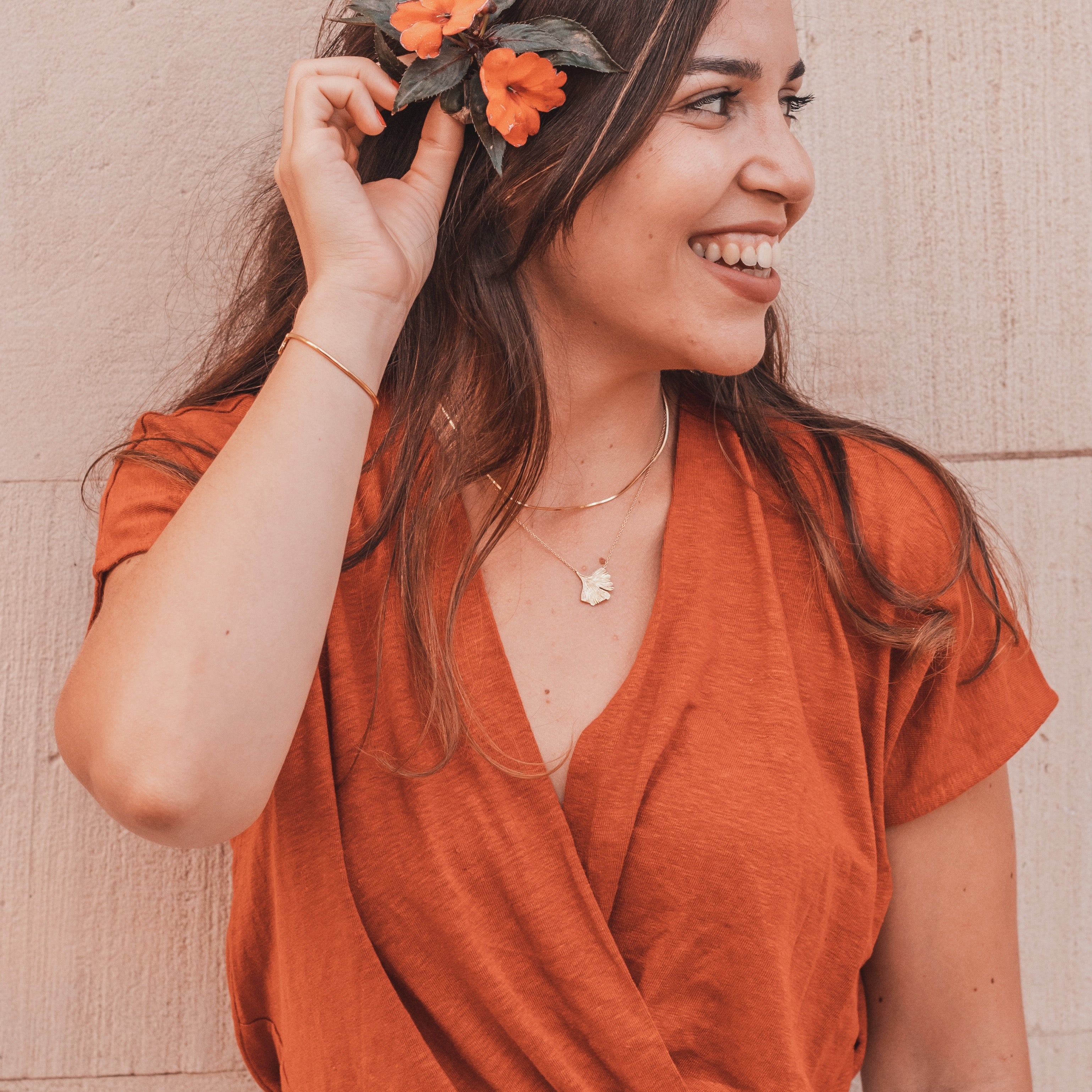 Ginkgo necklace in 18k gold vermeil worn on neck layered with another necklace