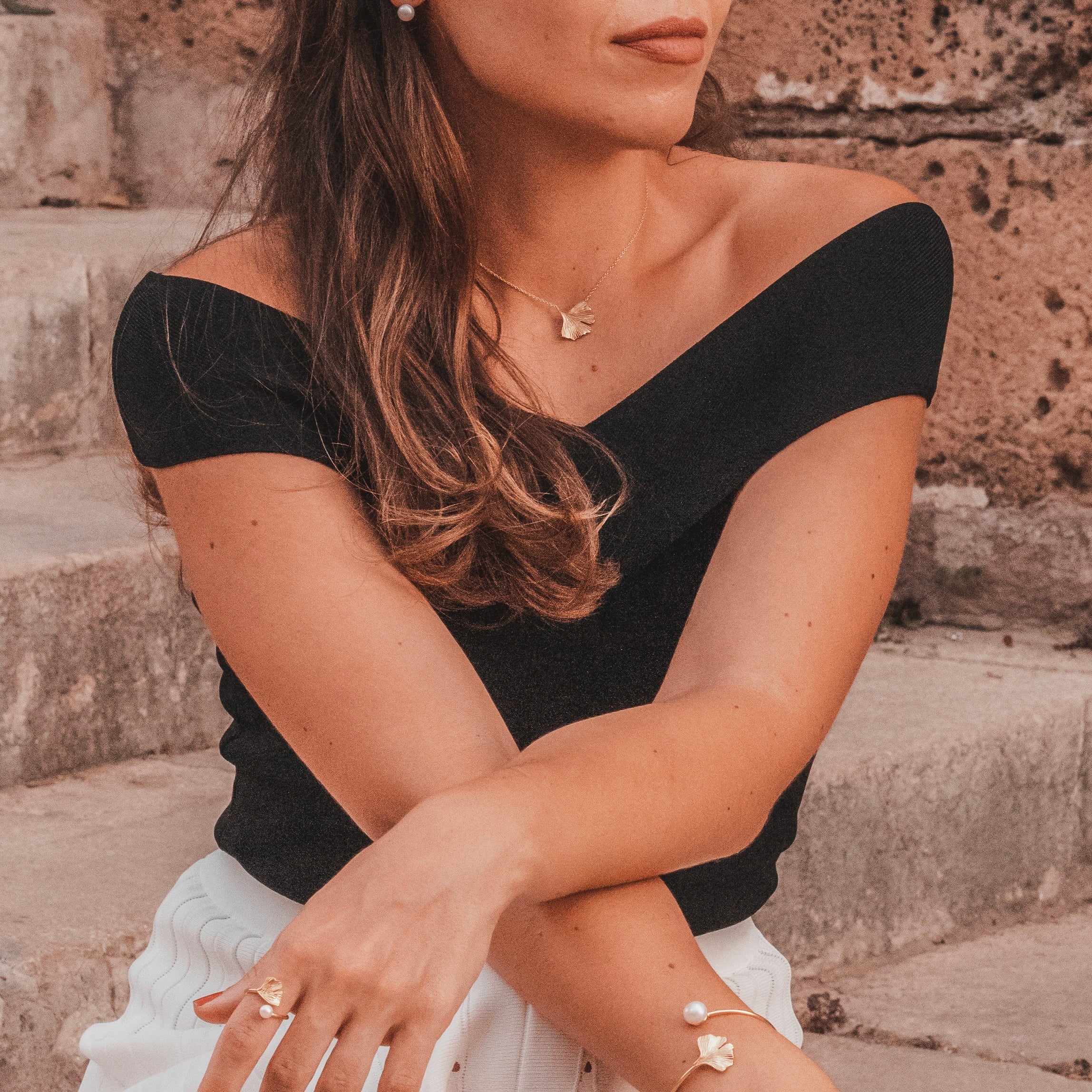 Ginkgo necklace in 18k gold vermeil worn on neck on model with classic chic clothes