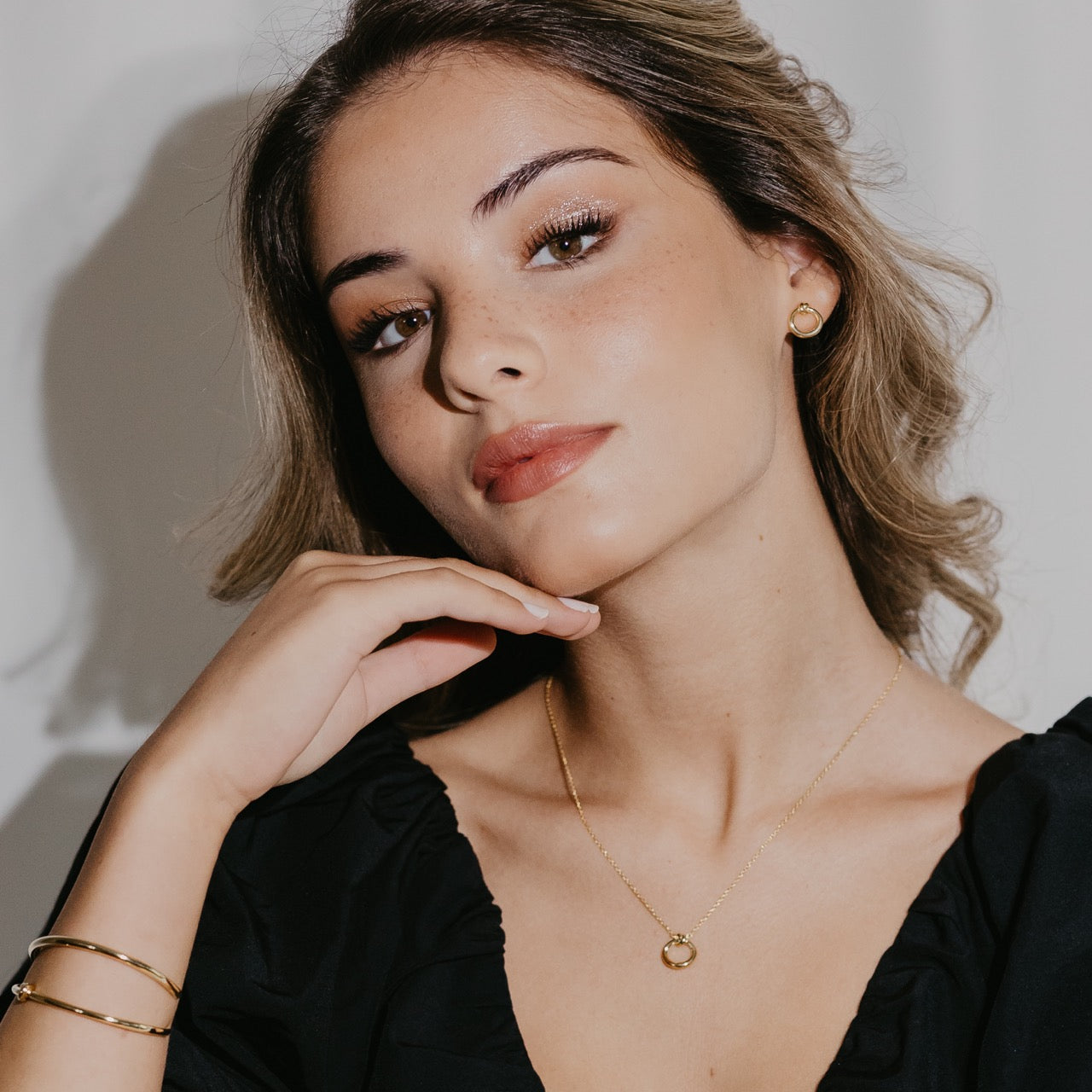 Knot collection earrings styled showing delicate circular rope knot design