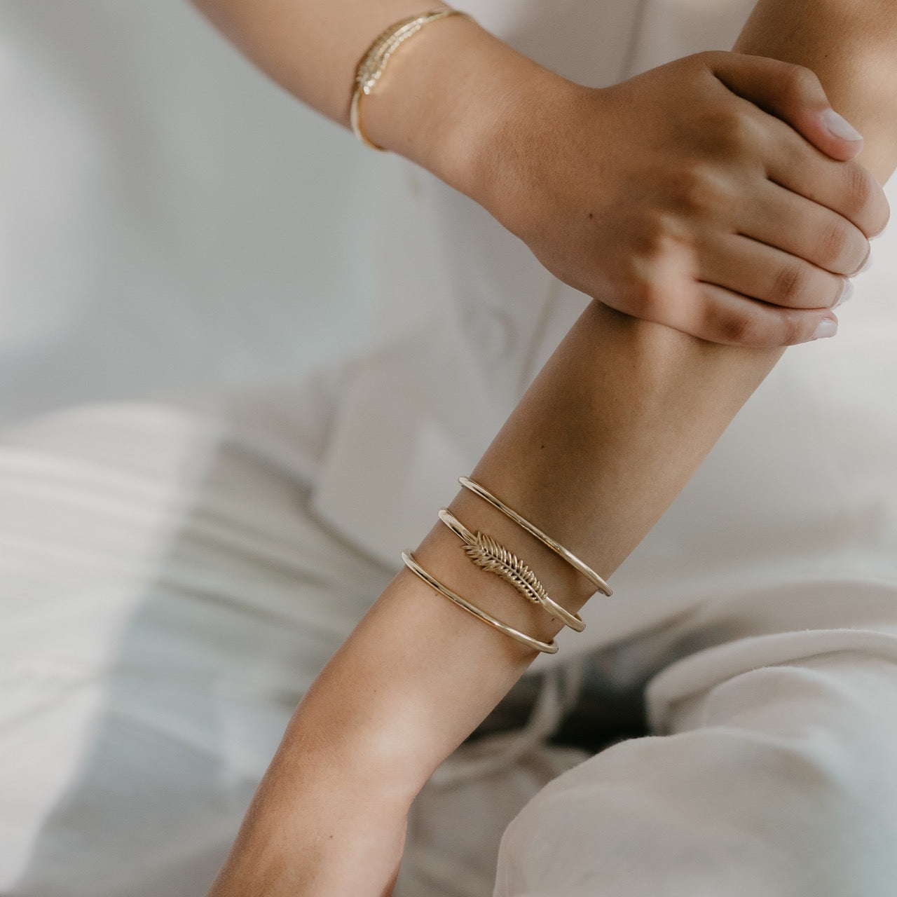 Close-up of palm leaf bracelet worn displaying delicate leaf design
