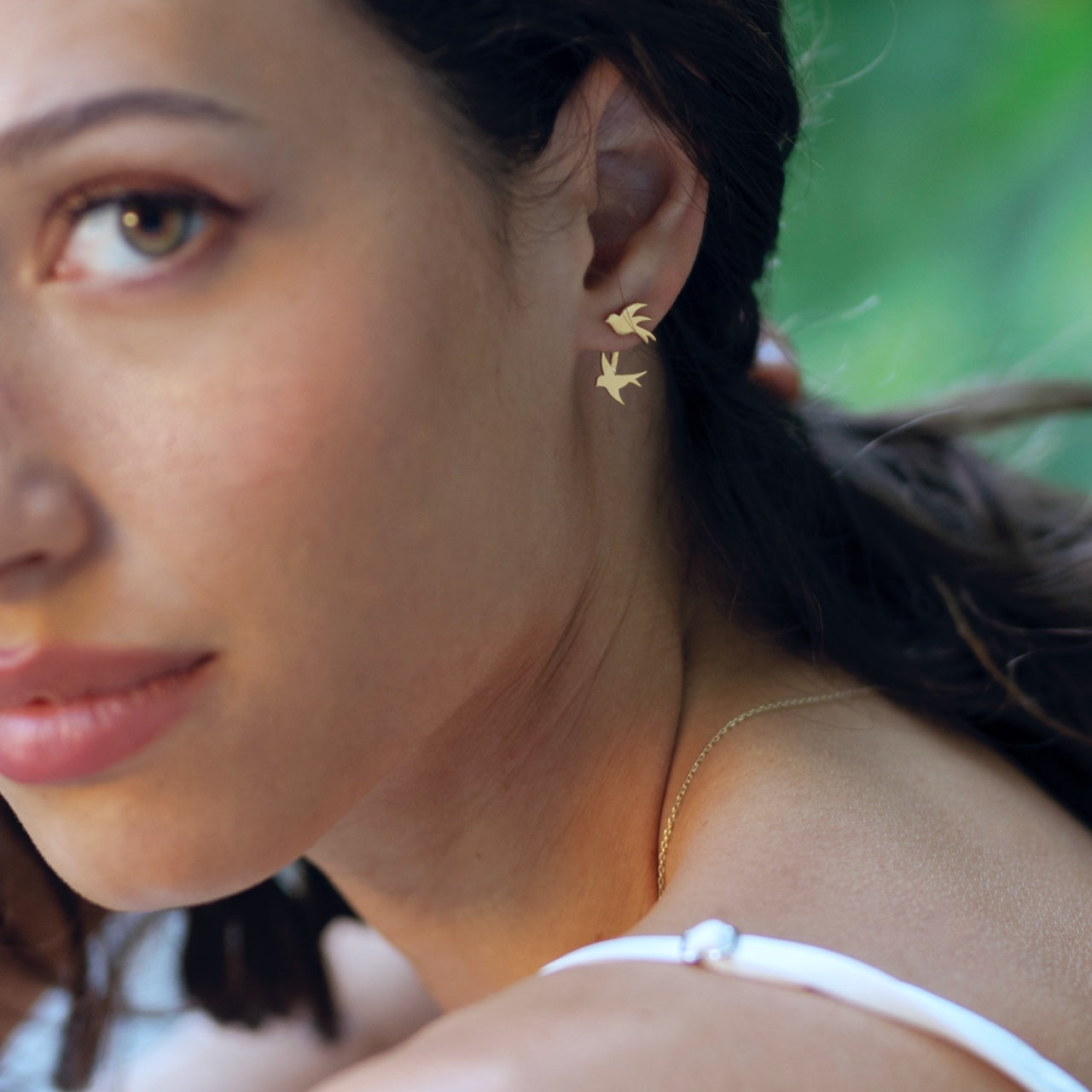 Swallow earrings in gold vermeil worn on ear