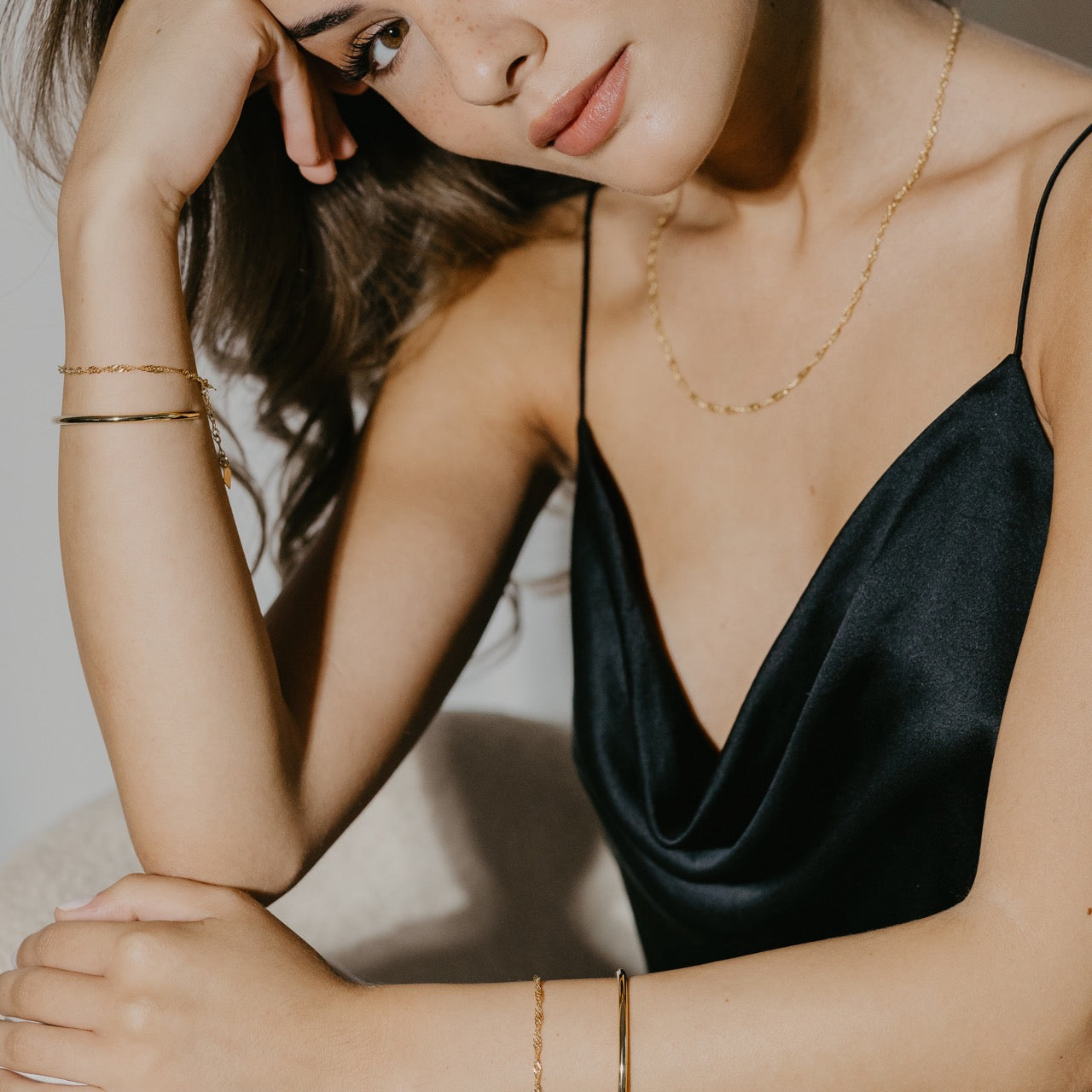 Close-up of Sleek twisted chain bracelet worn displaying chain movement and elegance