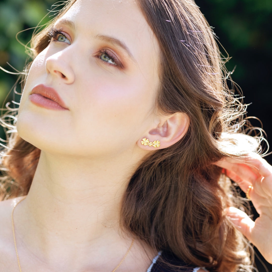 Clover stud and ear climber worn showing four-leaf clover design on ear