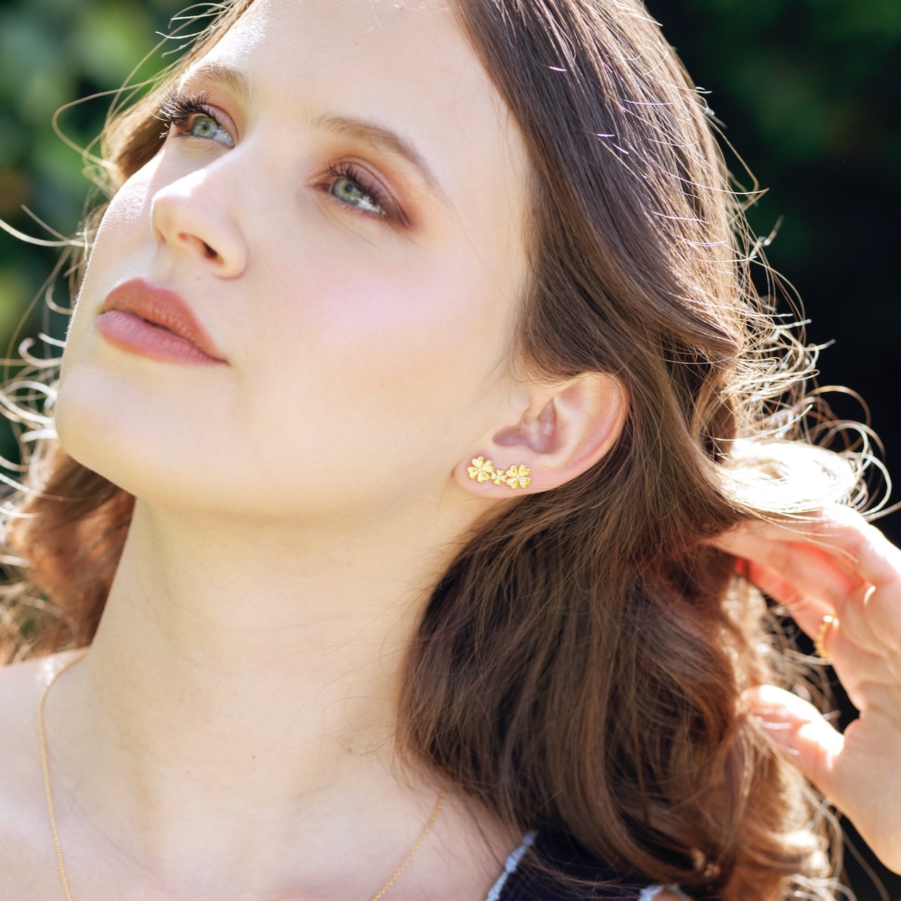 Clover stud and ear climber worn showing four-leaf clover design on ear