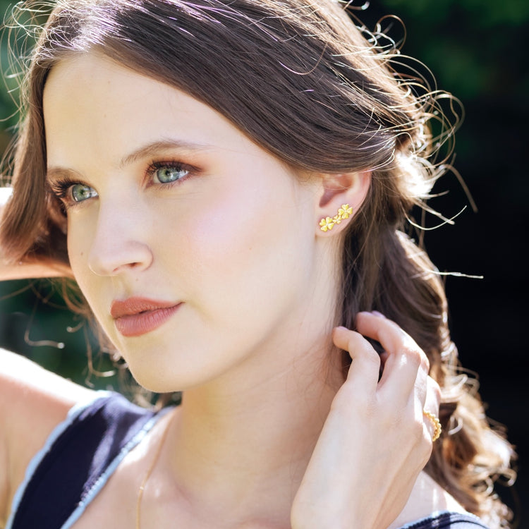 Origins collection clover earring set styled displaying versatile stud and climber combination