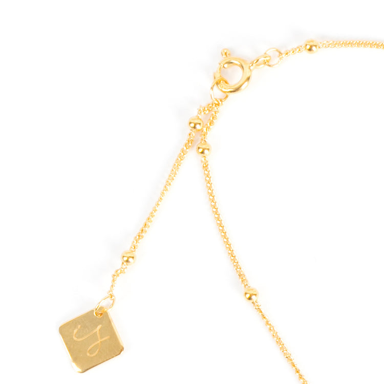 Close-up of freshwater pearl bracelet showing Inês Santos logo and adjustable clasp