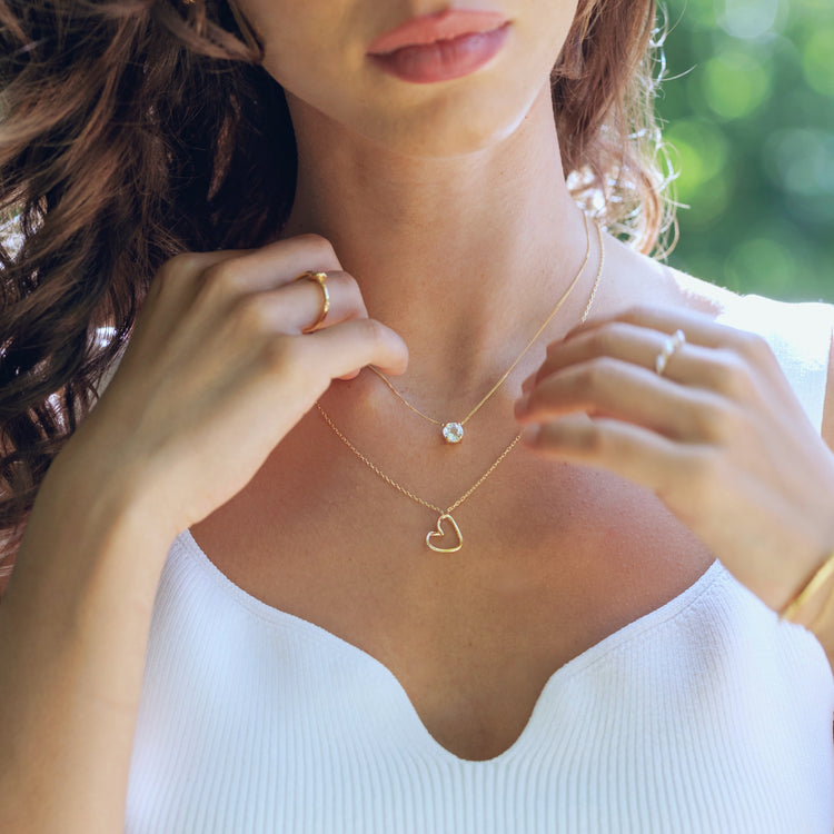 Heart silhouette necklace in gold vermeil worn on neck