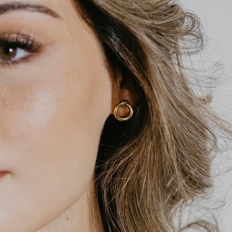 Knot circle earrings in gold vermeil worn on ear