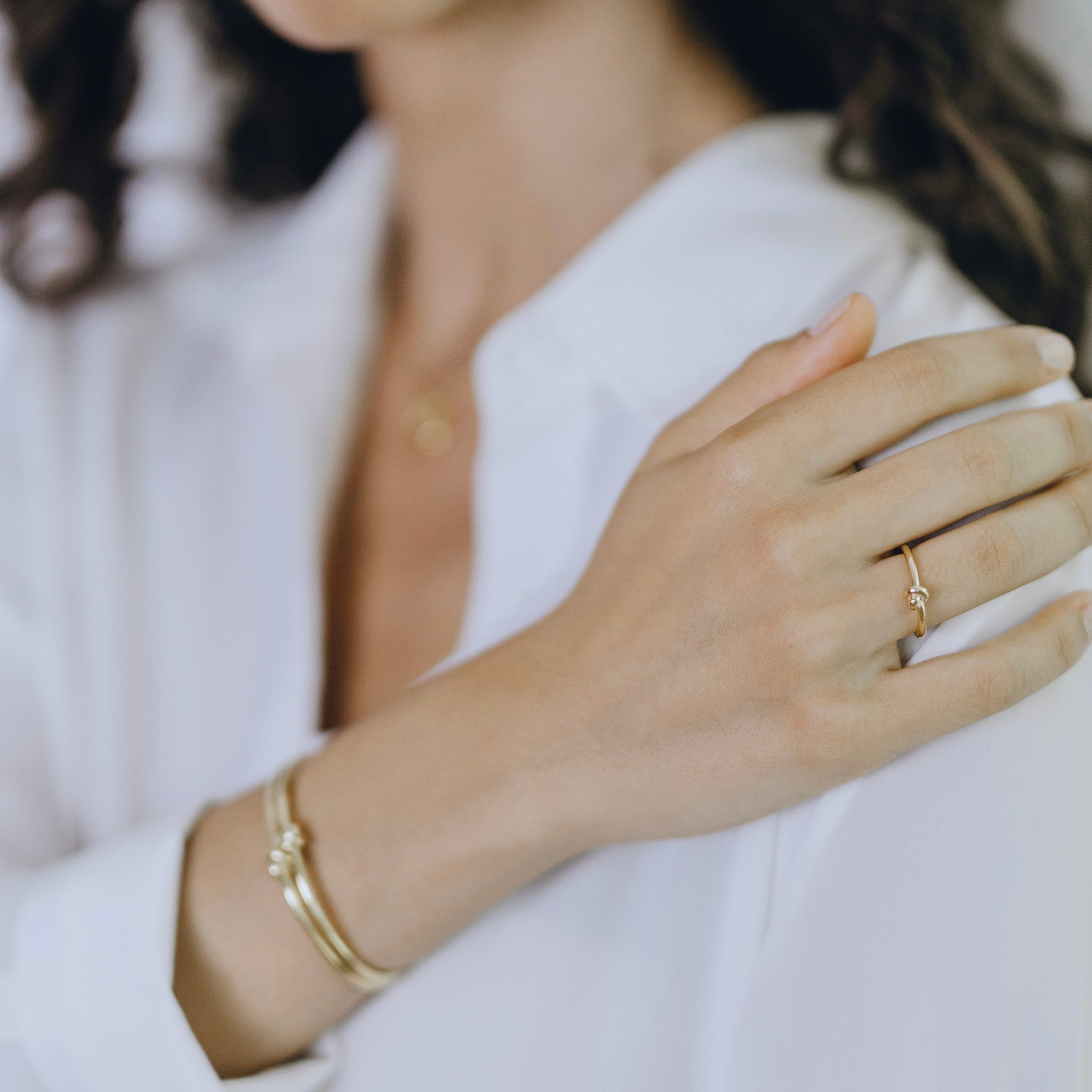 Close-up of Knot ring worn showing organic rope-like circular detail
