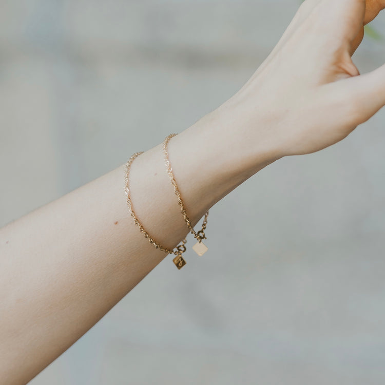 Sleek twisted chain bracelet in gold vermeil worn on wrist