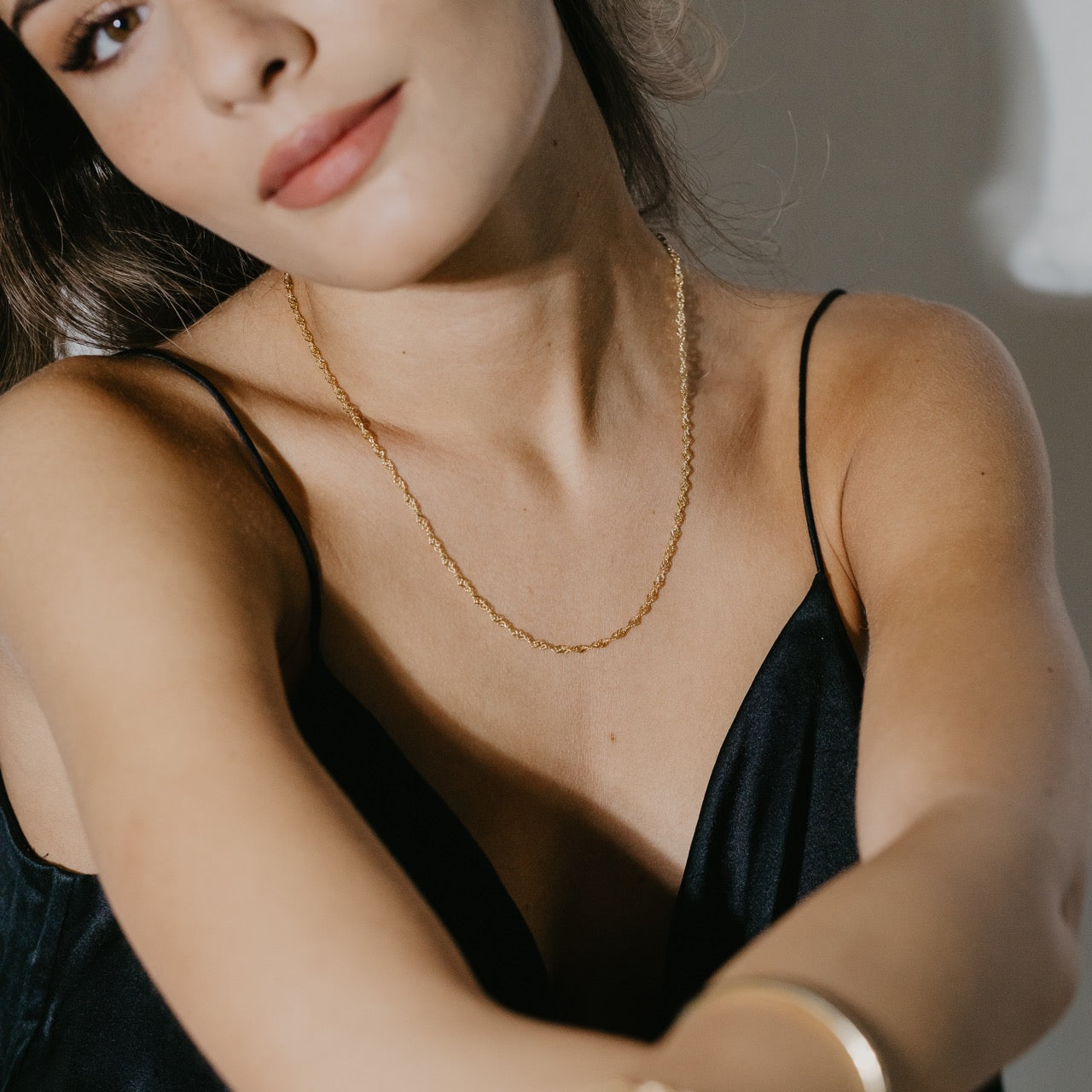 Sleek twisted chain necklace in gold vermeil worn on neck