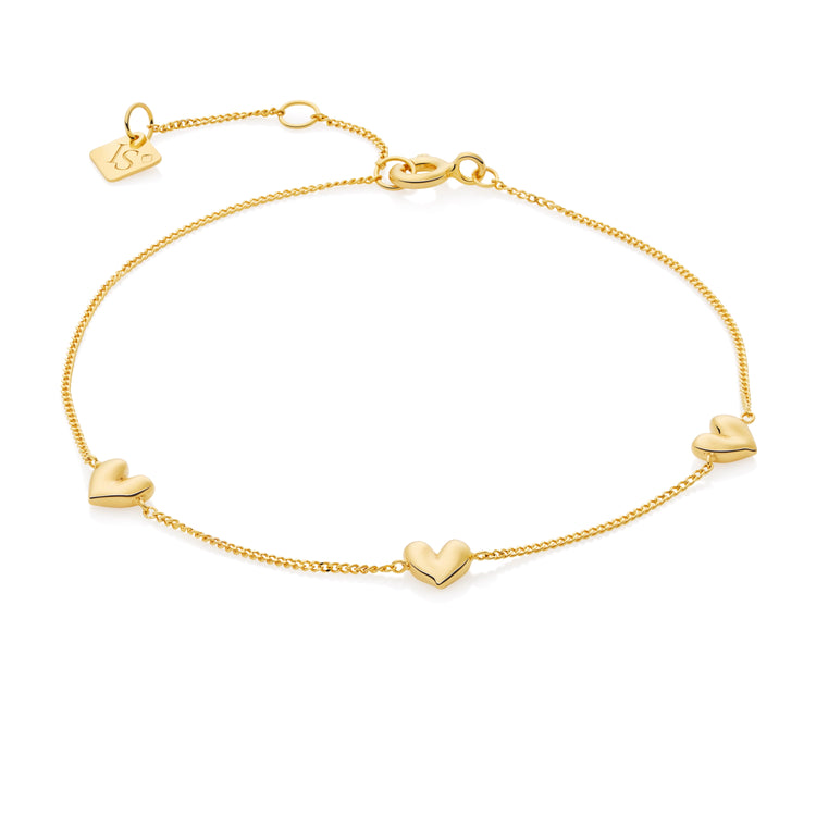 Gold bracelet with heart-shaped charms on a white background
