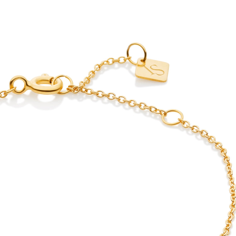 Close-up of a gold chain bracelet extender with a lobster clasp, small oval links, and a square engraved tag on a white background.