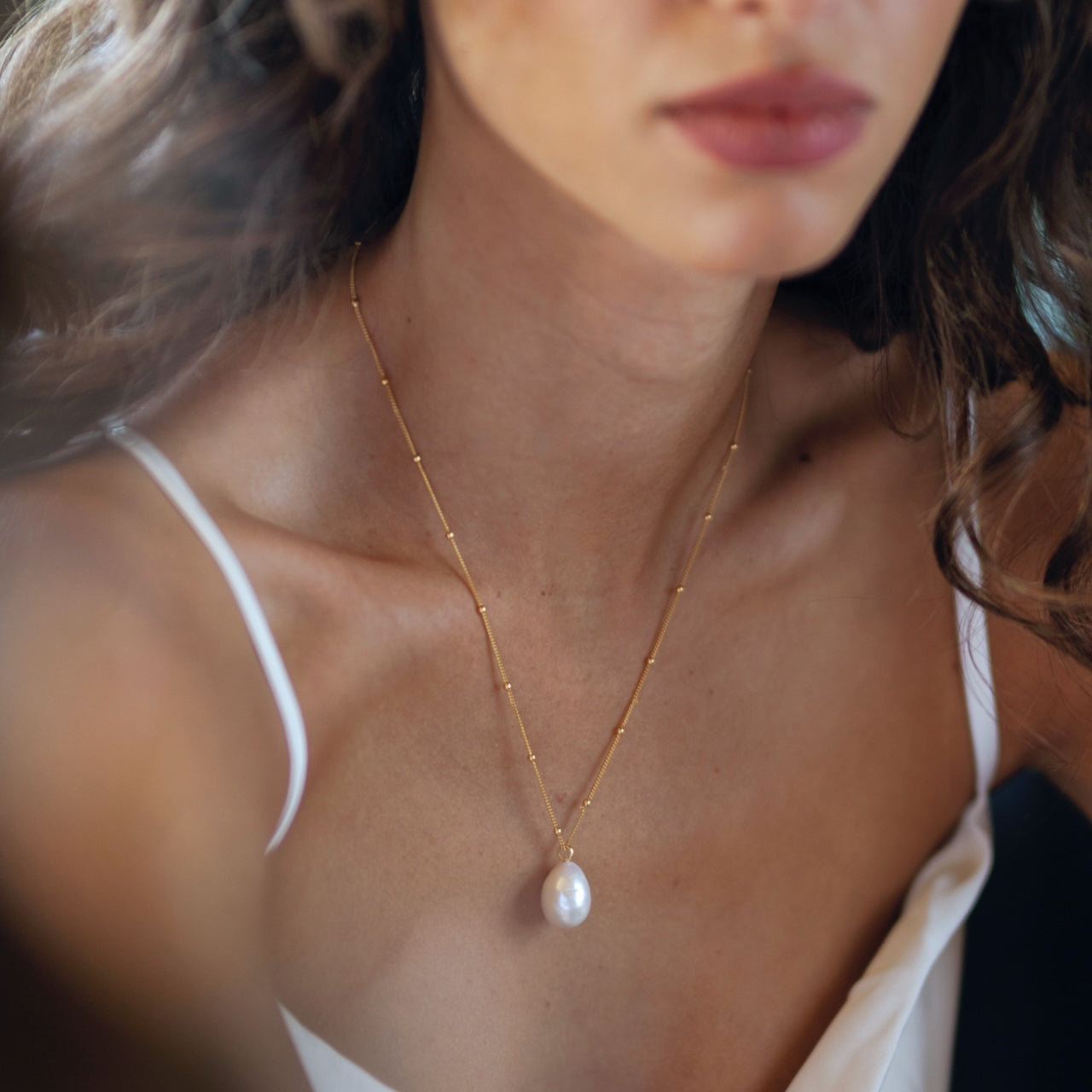 Close-up of baroque pearl necklace worn displaying unique natural pearl texture