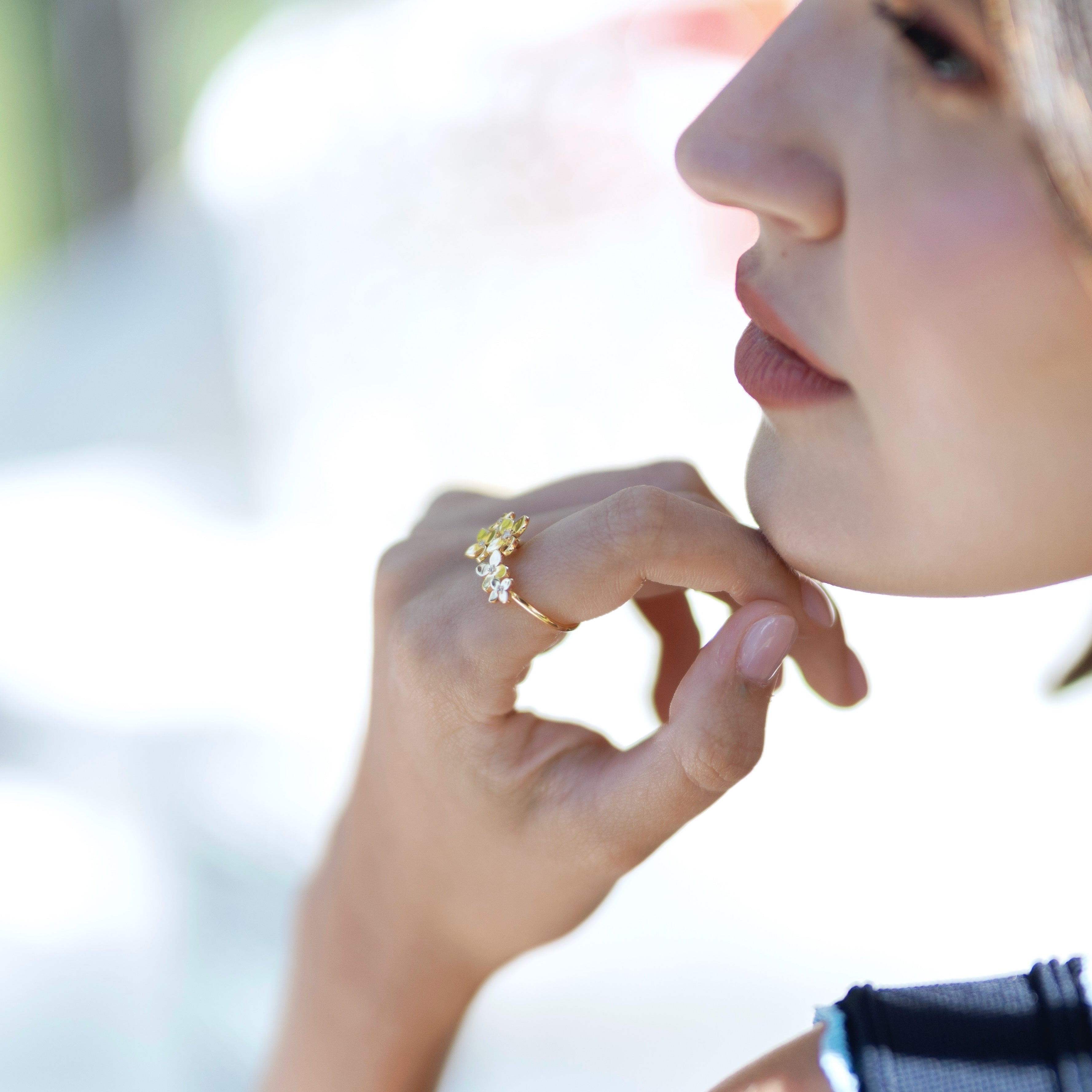 Close-up of Bloom ring worn displaying detailed hydrangea-inspired metalwork