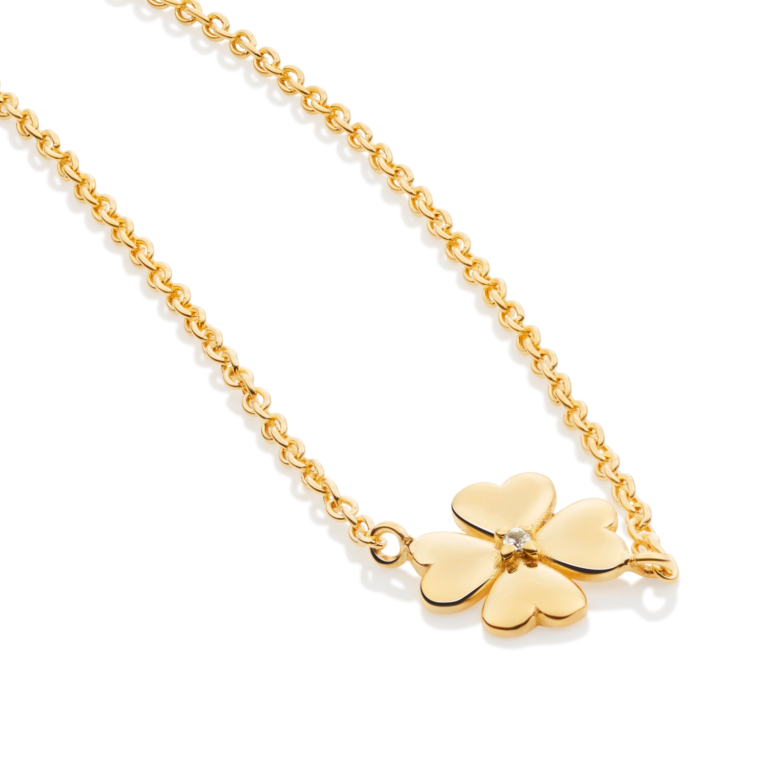 Close-up of clover bracelet showing detailed petal shape and white topaz center