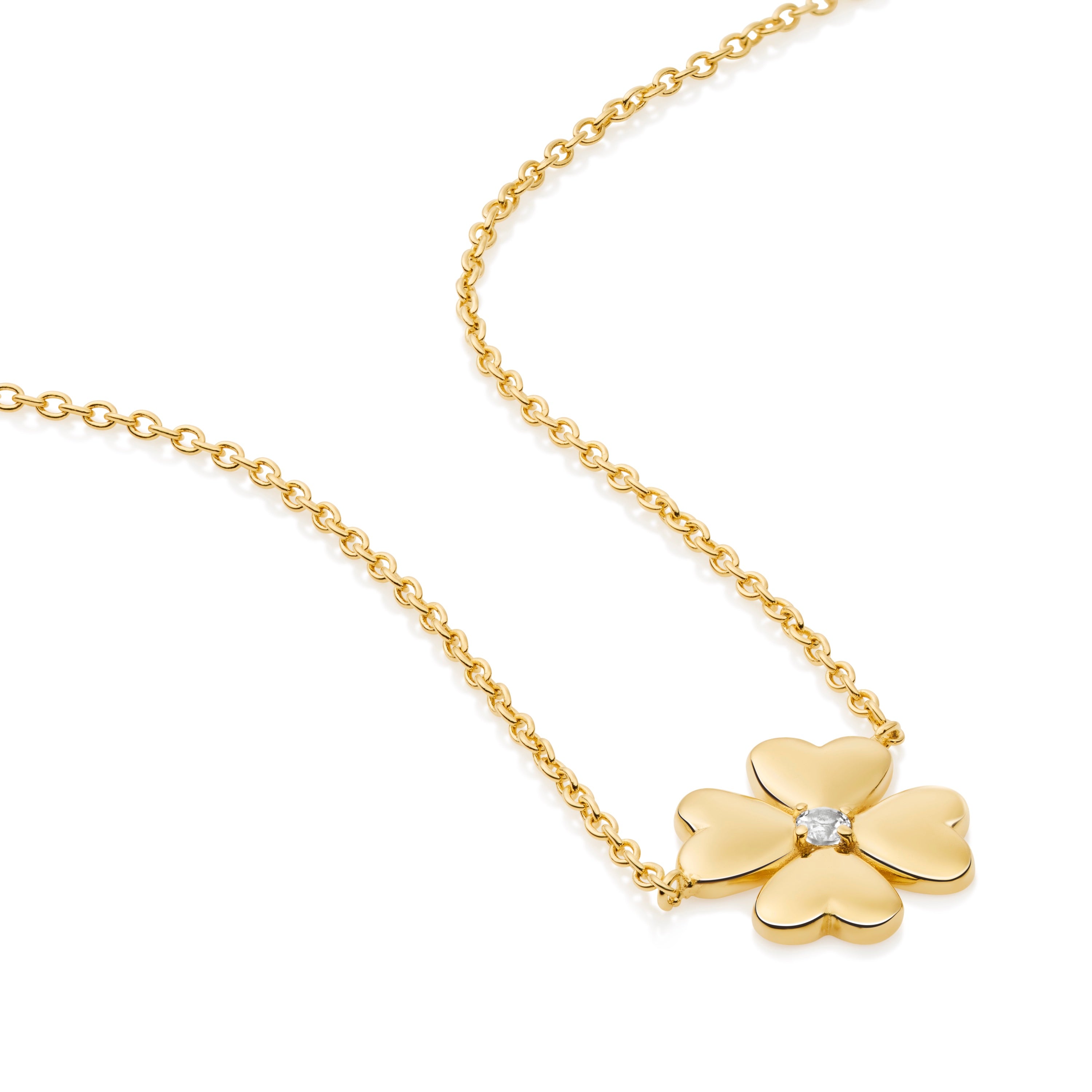 Close-up of clover necklace showing detailed petal shape and white topaz center