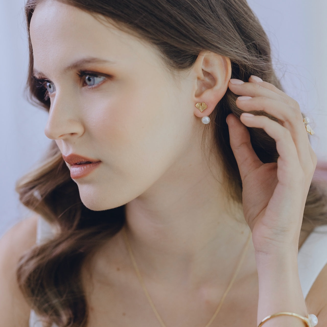 Ginkgo pearl drop earrings in gold vermeil worn with pearl attachment
