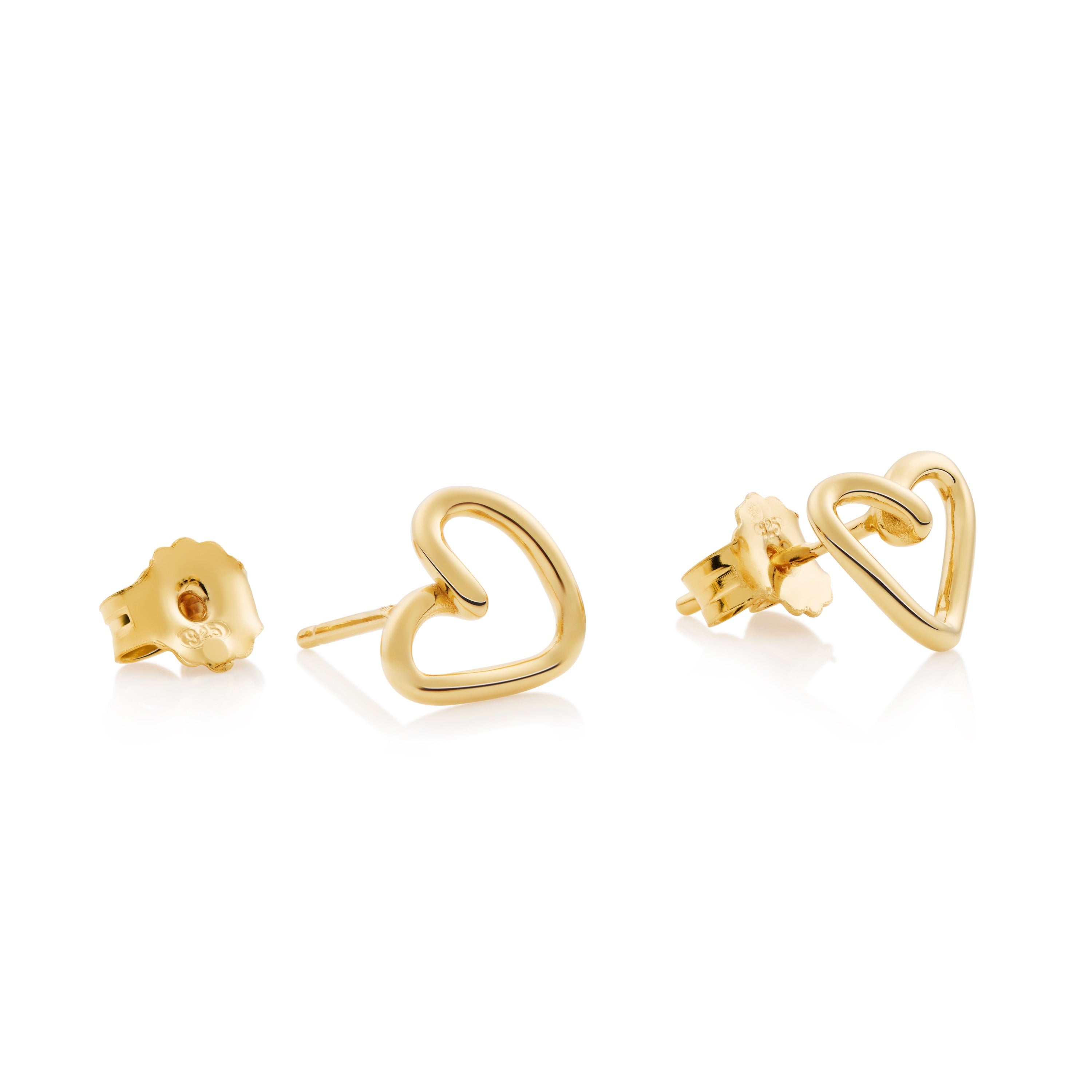 Close-up of heart earrings showing delicate silhouette outline and refined detail