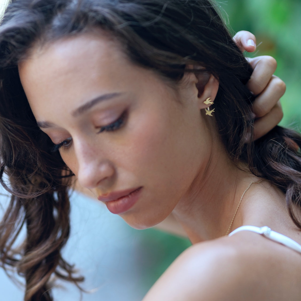 Origins collection swallow earrings styled showing delicate bird pendant detail