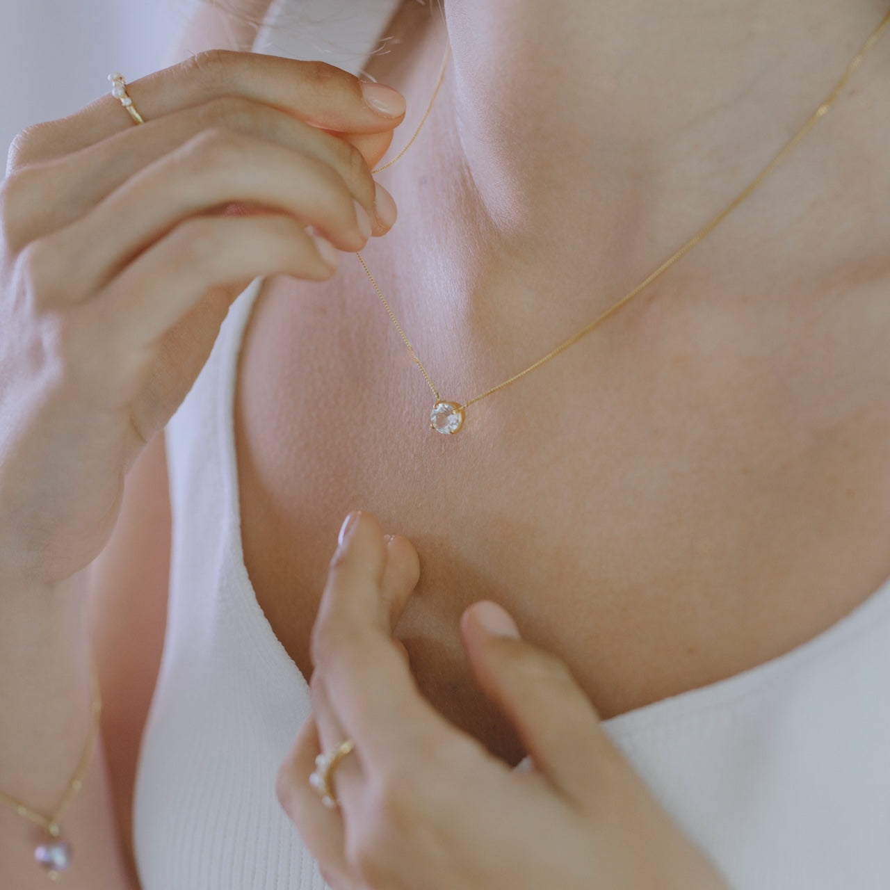 White topaz necklace styled showing delicate pendant length and placement