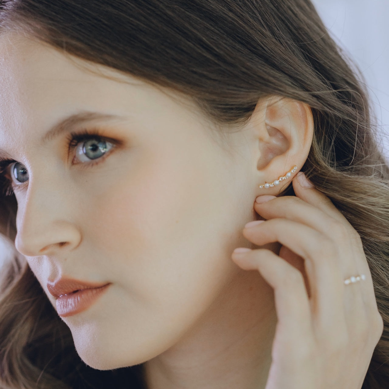 Pearl Obsession earrings styled showing topaz sparkle and pearl combination climbing design