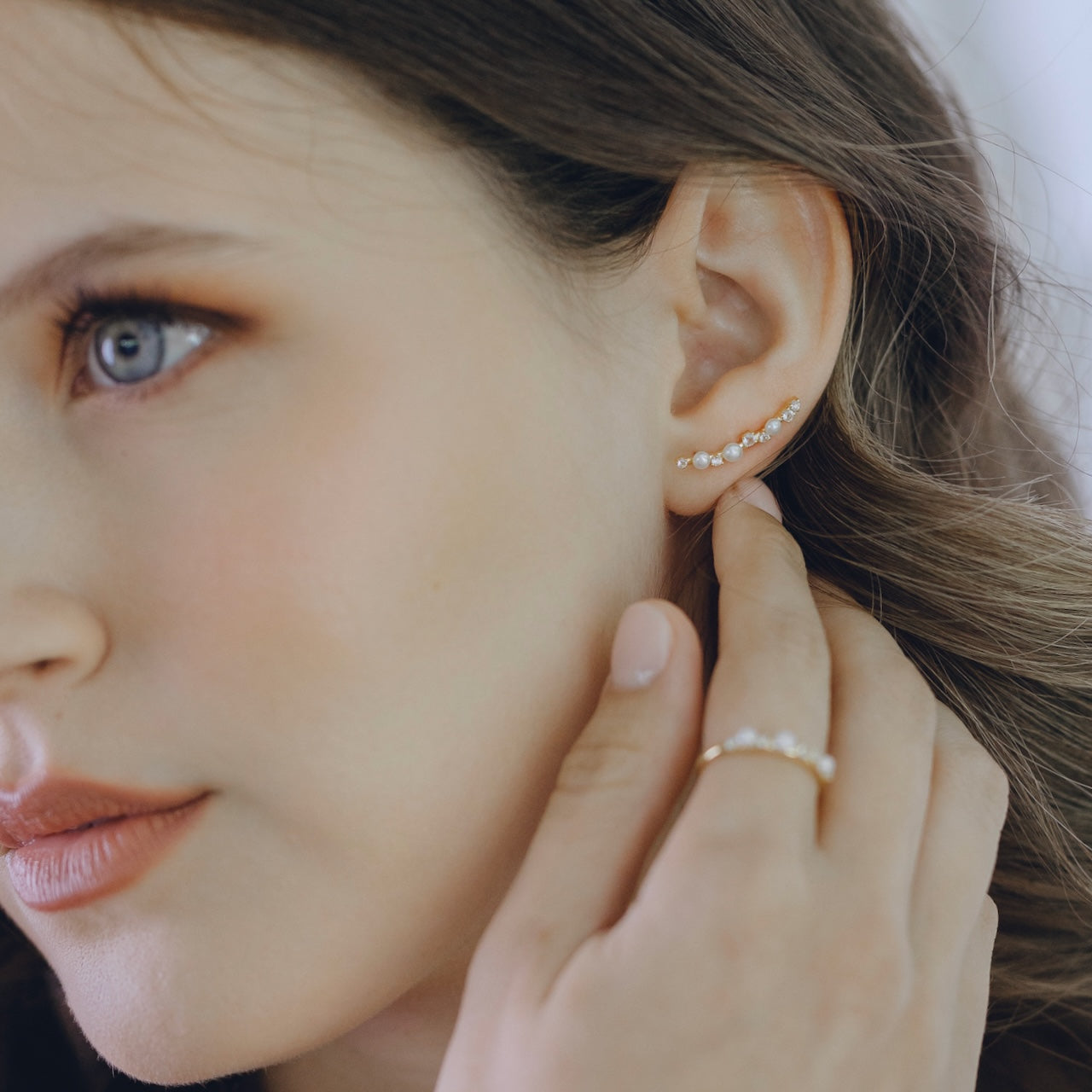 White topaz and pearl ear climbers in gold vermeil worn on ear