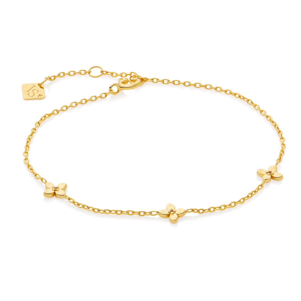 Gold bracelet with three small flower-shaped charms on a white background