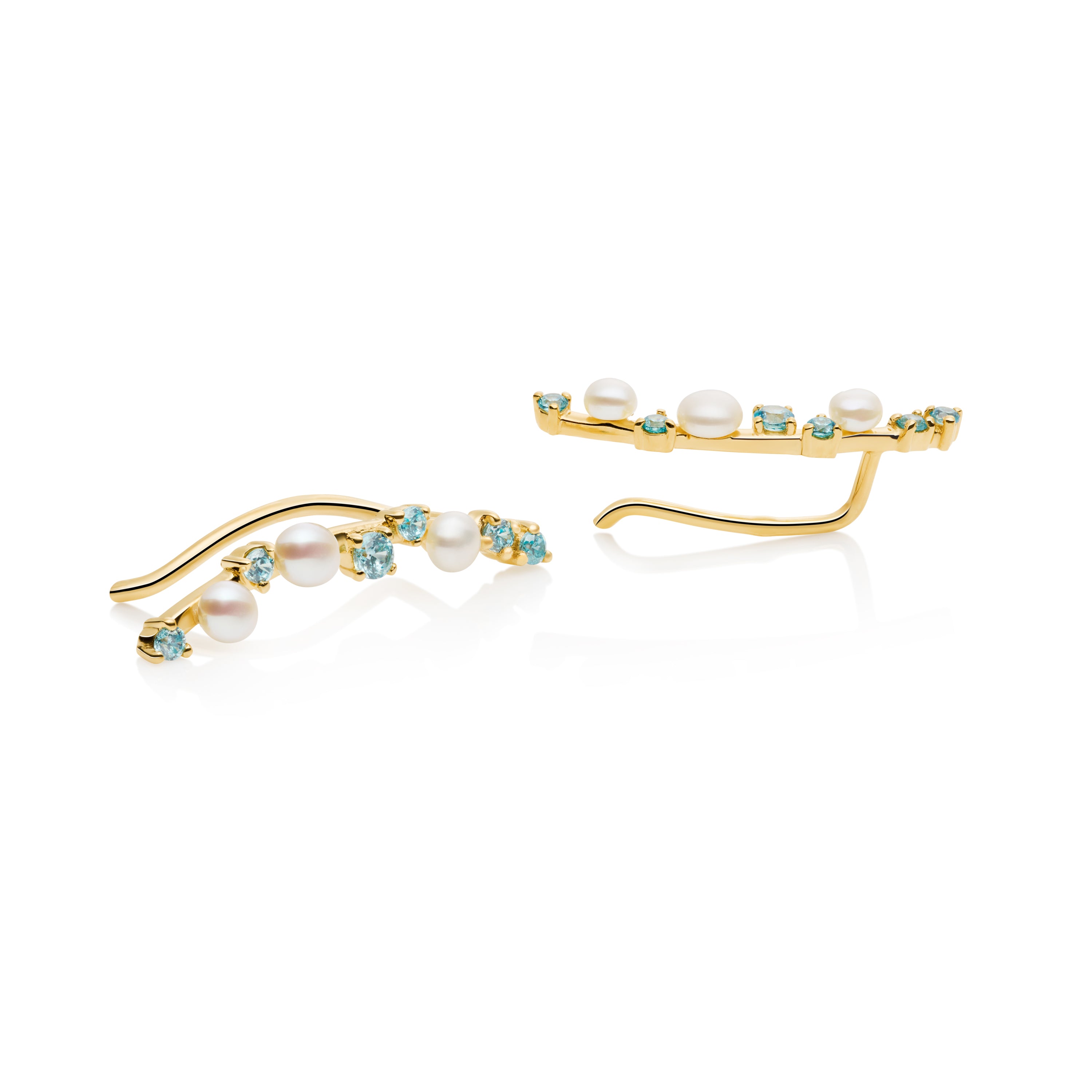 Close-up of blue topaz and pearl ear climbers showing gemstone arrangement and detail