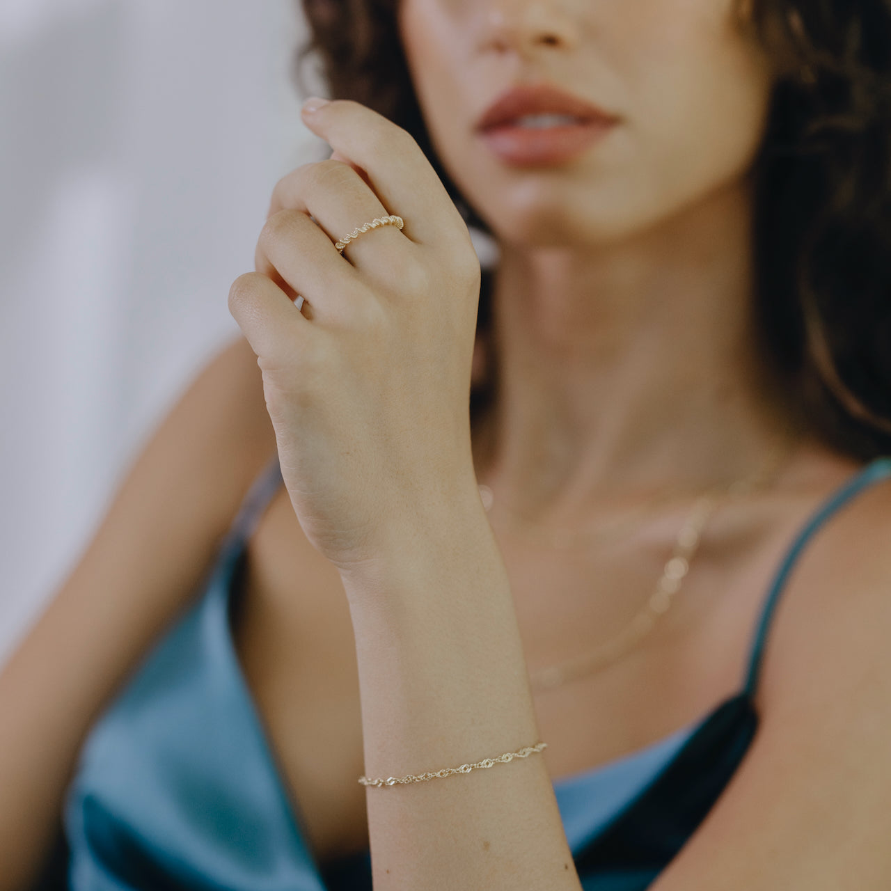 Side view of twist ring in gold vermeil showing sculptural curve and thickness