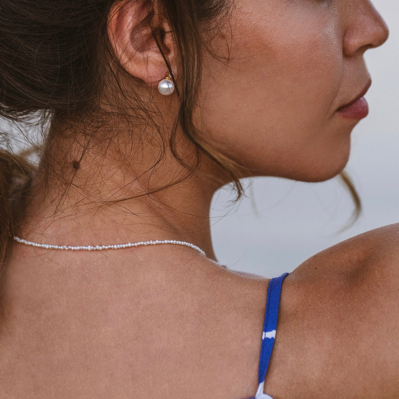 Close-up of mini pearl necklace worn displaying delicate freshwater pearls