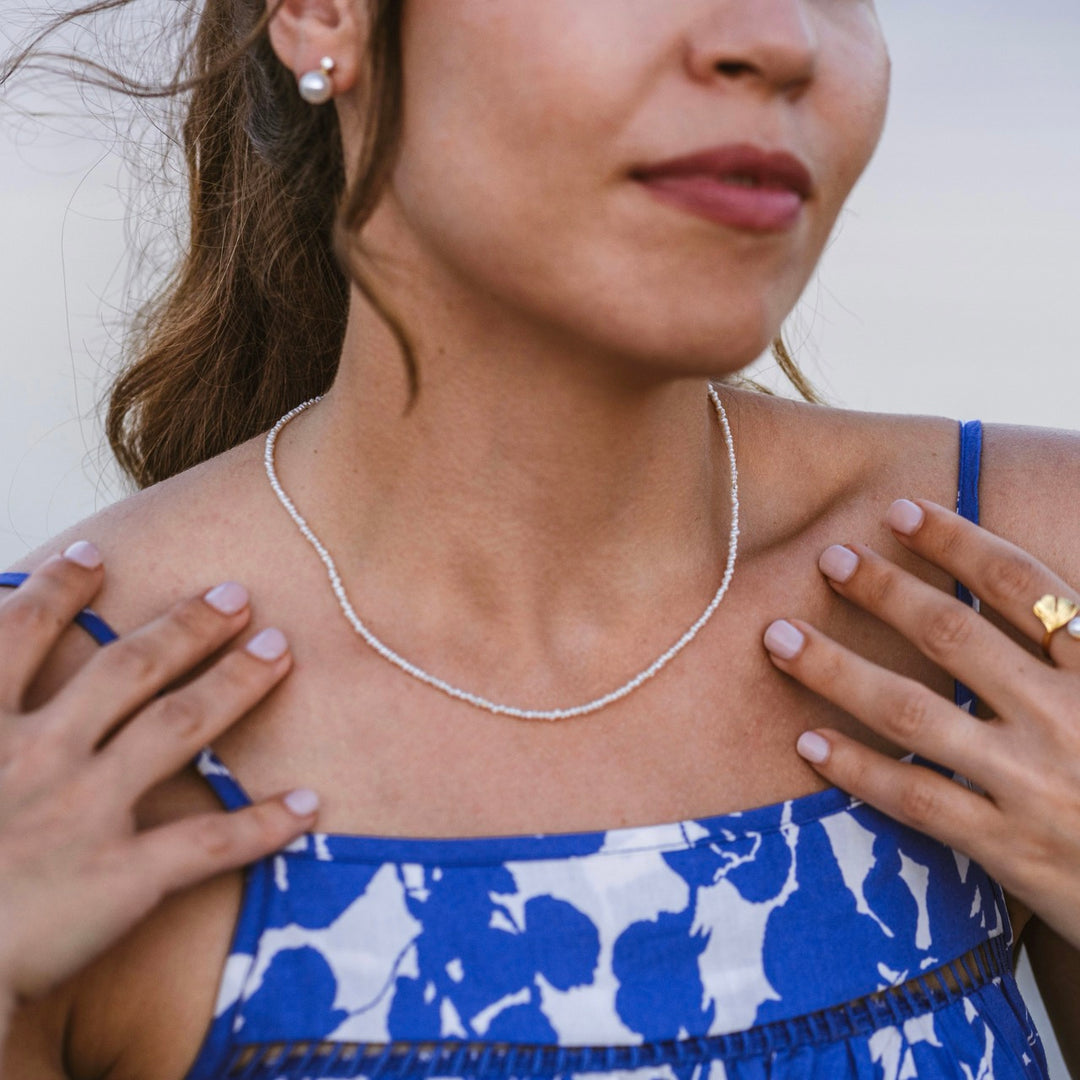 Mini pearl necklace in gold vermeil worn on neck showing delicate length