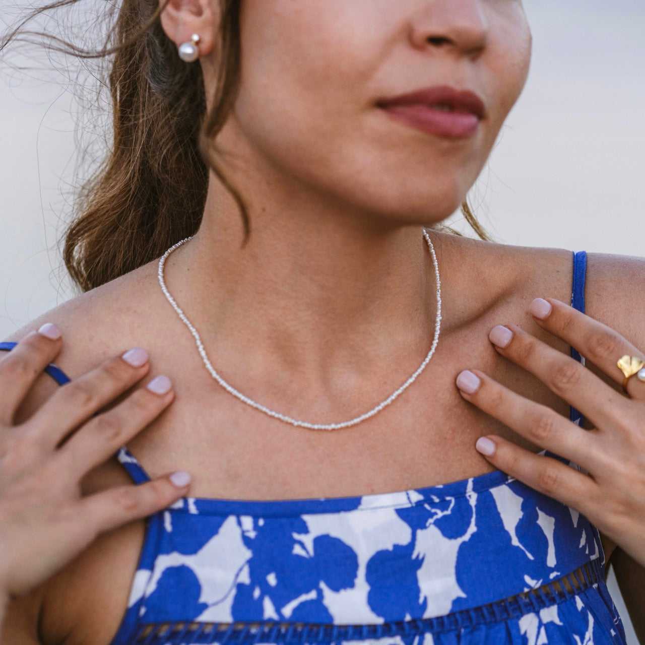 Mini pearl necklace in gold vermeil worn on neck showing delicate length